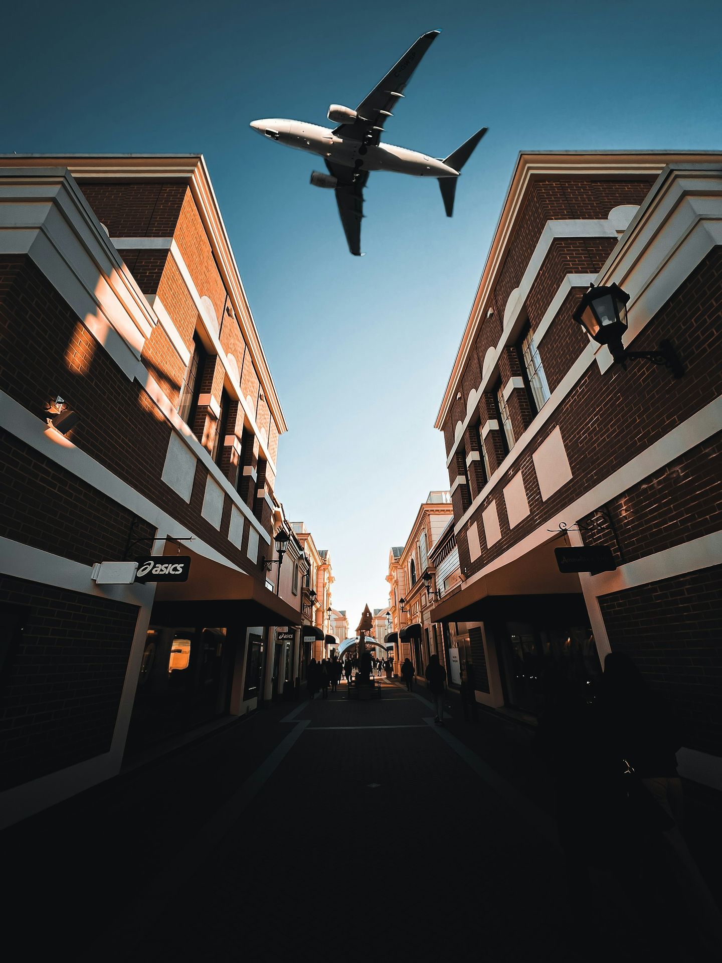 an airplane is flying over a city street